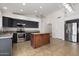 Modern kitchen features stainless steel appliances, dark cabinets, and a butcher block island at 17201 N Chance Dr, Surprise, AZ 85374