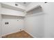 Bright laundry room with white walls, shelving, and tile flooring for a clean and organized space at 17201 N Chance Dr, Surprise, AZ 85374