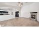 Open-concept living area with a fireplace, tile flooring, and kitchen access at 17201 N Chance Dr, Surprise, AZ 85374