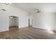 Spacious living room with tile and laminate flooring, ceiling fan, and arched doorways at 17201 N Chance Dr, Surprise, AZ 85374
