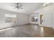 Open living room with large windows, laminate flooring, and access to the front entrance at 17201 N Chance Dr, Surprise, AZ 85374