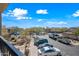 Condominiums overlook well-maintained street with parked cars under a beautiful blue sky at 19700 N 76Th St # 2044, Scottsdale, AZ 85255