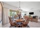 Dining area with a chandelier, wood furnishings, and sliding door access to the patio at 19700 N 76Th St # 2044, Scottsdale, AZ 85255