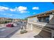 Two-story condominium showcasing garage, balcony, and community landscape under blue skies at 19700 N 76Th St # 2044, Scottsdale, AZ 85255