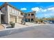 Attractive condo building with desert landscaping, a private garage, and nearby parking on a sunny day at 19700 N 76Th St # 2044, Scottsdale, AZ 85255