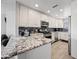 Bright kitchen with white cabinetry, granite counters, and stainless steel appliances at 19700 N 76Th St # 2044, Scottsdale, AZ 85255