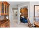 View of the living room with an antique hutch and access to the hallway and an office at 19700 N 76Th St # 2044, Scottsdale, AZ 85255