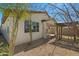 Charming backyard featuring a wooden pergola and a view of the home's exterior at 20056 N 107Th Ln, Peoria, AZ 85373