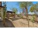 Backyard with a wooden pergola and space for outdoor activities at 20056 N 107Th Ln, Peoria, AZ 85373