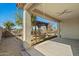 Covered backyard patio with a view of the wooden pergola and landscaped yard at 20056 N 107Th Ln, Peoria, AZ 85373
