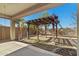 Backyard patio with a covered area and a charming wooden pergola at 20056 N 107Th Ln, Peoria, AZ 85373