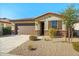 Single-story home with a brown garage door, desert landscaping, and a tiled roof at 20056 N 107Th Ln, Peoria, AZ 85373