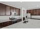 The stylish kitchen features granite countertops, stainless steel appliances, and dark wood cabinetry at 20056 N 107Th Ln, Peoria, AZ 85373