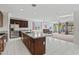 Kitchen with dark wood island, tile floor, and view to the living room at 20056 N 107Th Ln, Peoria, AZ 85373