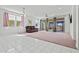 Bright living room with a ceiling fan, tile entryway, and sliding glass door at 20056 N 107Th Ln, Peoria, AZ 85373
