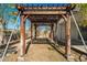 Wooden pergola in the backyard, offering shade and a decorative element at 20056 N 107Th Ln, Peoria, AZ 85373