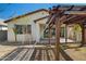 Well-lit backyard with a charming pergola, ideal for outdoor relaxation and entertainment at 20056 N 107Th Ln, Peoria, AZ 85373