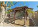 Backyard pergola, adjacent to the covered patio and a well-maintained yard at 20056 N 107Th Ln, Peoria, AZ 85373
