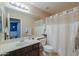 A bright bathroom with a large vanity, framed mirror, and shower-tub combo at 2126 E Sherri Ct, Gilbert, AZ 85296