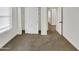 Neutral-toned bedroom featuring sliding closet doors and plush carpet flooring at 2181 W Harmont Dr, Phoenix, AZ 85021
