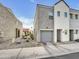 Street view of a modern stucco townhome with a single-car garage and rock landscaping at 2181 W Harmont Dr, Phoenix, AZ 85021