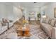 Bright living room with hardwood floors, neutral furniture, area rug, and decor at 2181 W Harmont Dr, Phoenix, AZ 85021