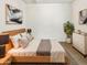 Cozy bedroom with light wood furniture, neutral bedding, and modern artwork at 2181 W Harmont Dr, Phoenix, AZ 85021
