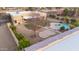 Aerial view of backyard featuring a pool, decorative concrete, desert landscaping and perimeter fencing at 22941 W Blue Sky Dr, Wittmann, AZ 85361