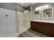 Bathroom showcasing a glass-enclosed shower, double sink vanity with stylish mirrors, and modern fixtures at 2297 E Mews Rd, Gilbert, AZ 85298