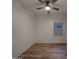 Bright bedroom with a modern ceiling fan, wood-look flooring and a large window providing natural light at 2297 E Mews Rd, Gilbert, AZ 85298