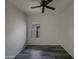 Bright bedroom with a modern ceiling fan, dark floors and a large window providing natural light at 2297 E Mews Rd, Gilbert, AZ 85298