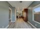 Open kitchen with stainless steel appliances, recessed lighting, breakfast bar, and sleek wood cabinets and flooring at 2297 E Mews Rd, Gilbert, AZ 85298