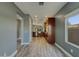 Open kitchen with stainless steel appliances, recessed lighting, breakfast bar, and sleek wood cabinets and flooring at 2297 E Mews Rd, Gilbert, AZ 85298