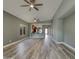 Open-concept living space featuring hardwood floors, modern lighting, and access to the kitchen at 2297 E Mews Rd, Gilbert, AZ 85298