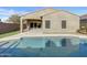 Backyard with a refreshing pool and covered patio, perfect for outdoor entertaining and relaxing at 2297 E Mews Rd, Gilbert, AZ 85298