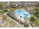 Aerial view of a community pool featuring lounge seating, a spa, shade structures, and well-manicured landscaping at 2367 W Dusty Wren Dr, Phoenix, AZ 85085