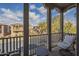 View from the balcony overlooking the street with chairs and a table at 2367 W Dusty Wren Dr, Phoenix, AZ 85085