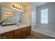 Bright bathroom featuring dual sinks, a soaking tub, and stylish lighting at 2367 W Dusty Wren Dr, Phoenix, AZ 85085