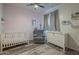 Comfortable Bedroom with crib, glider, and changing table at 2367 W Dusty Wren Dr, Phoenix, AZ 85085