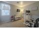 Multipurpose bedroom with desk, television and treadmill at 2367 W Dusty Wren Dr, Phoenix, AZ 85085