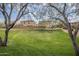 A green grassy area provides a peaceful common space in the community with mature trees at 2367 W Dusty Wren Dr, Phoenix, AZ 85085