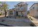 Charming two-story home with a balcony, desert landscaping, and a brick walkway at 2367 W Dusty Wren Dr, Phoenix, AZ 85085