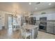 Well-lit kitchen features stainless steel appliances, a large island, and a dining area at 2367 W Dusty Wren Dr, Phoenix, AZ 85085