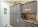 Charming kitchen with gray cabinets, granite countertop, and decorative backsplash at 2367 W Dusty Wren Dr, Phoenix, AZ 85085