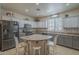 Spacious kitchen equipped with stainless steel appliances, and stylish two-tone cabinets at 2367 W Dusty Wren Dr, Phoenix, AZ 85085