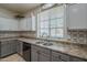 This kitchen features modern countertops, a stainless steel sink, and stylishly patterned backsplash at 2367 W Dusty Wren Dr, Phoenix, AZ 85085