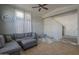 Cozy living room showcasing a comfortable sectional, neutral color scheme, and playroom area at 2367 W Dusty Wren Dr, Phoenix, AZ 85085