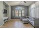 Bright living room features a vaulted ceiling, large windows, tile floor, and comfortable seating at 2367 W Dusty Wren Dr, Phoenix, AZ 85085