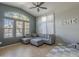 Spacious living room featuring a vaulted ceiling, large windows, and a comfortable gray sectional at 2367 W Dusty Wren Dr, Phoenix, AZ 85085