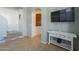 Open-concept living area showcasing a white console table and staircase with safety gate at 2367 W Dusty Wren Dr, Phoenix, AZ 85085